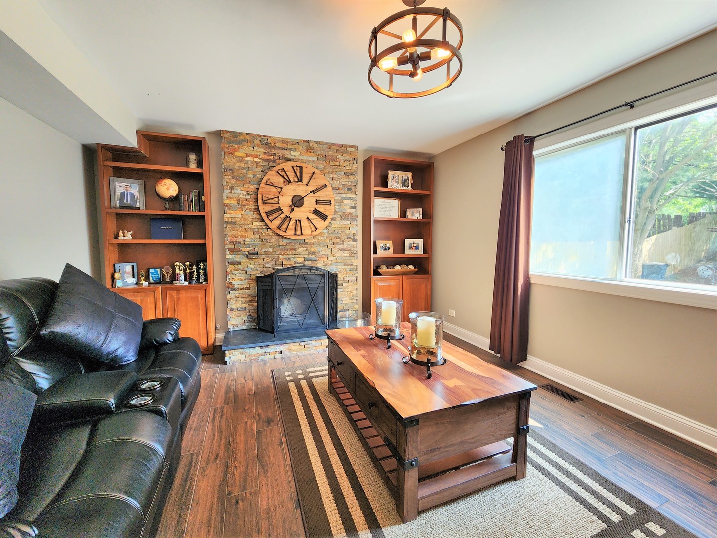 696 Dover Drive Elgin, IL 60120 - Photo 12 of 32 a living room with furniture a fireplace and a large window