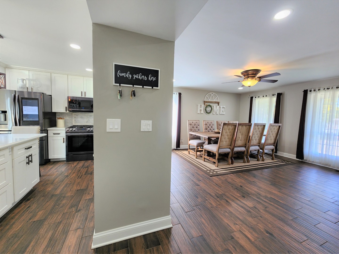 696 Dover Drive Elgin, IL 60120 - Photo 13 of 32 a living room with stainless steel appliances kitchen island hardwood floor and a view of kitchen