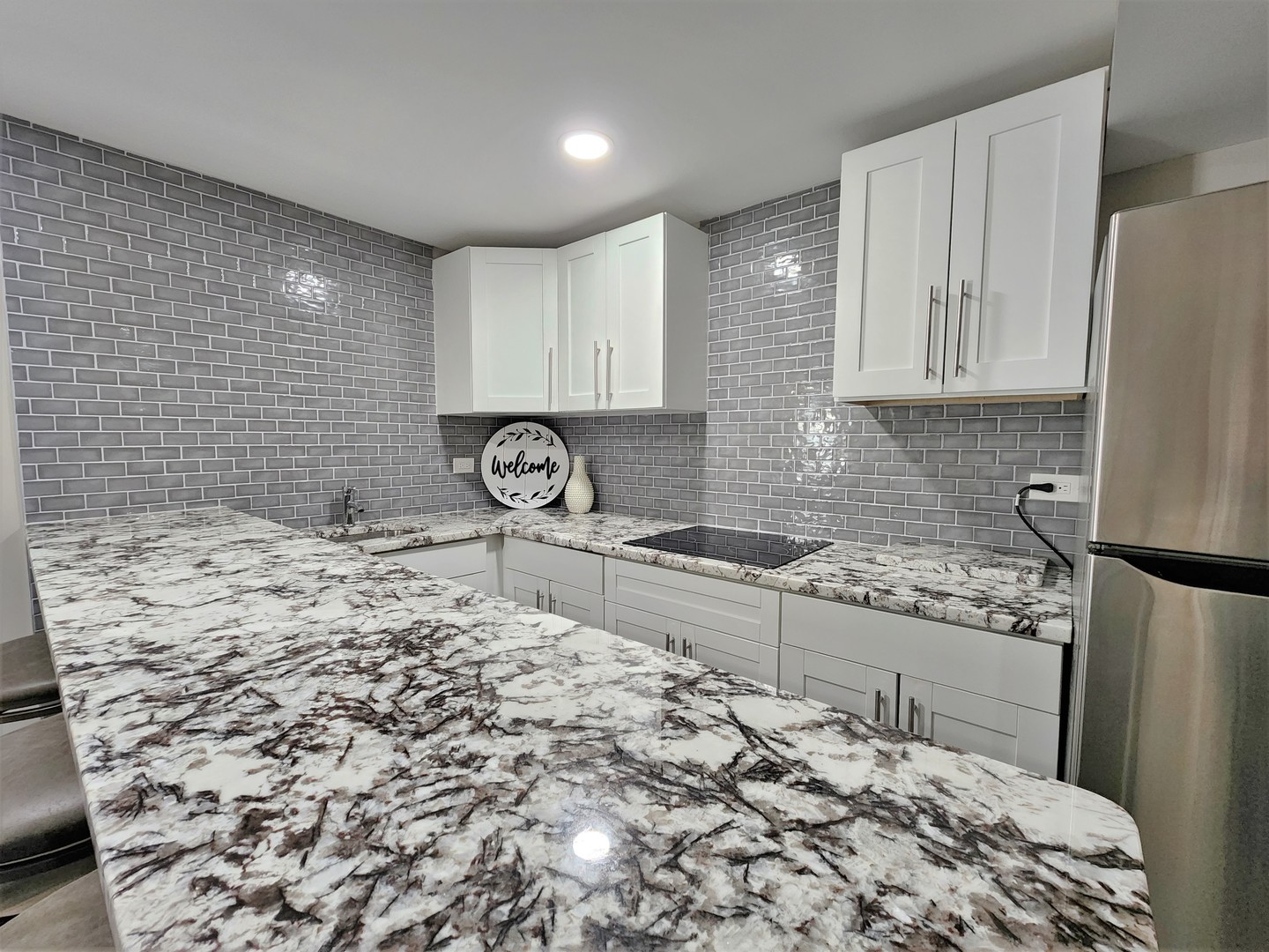 696 Dover Drive Elgin, IL 60120 - Photo 24 of 32 a kitchen with a sink a stove cabinets and a refrigerator