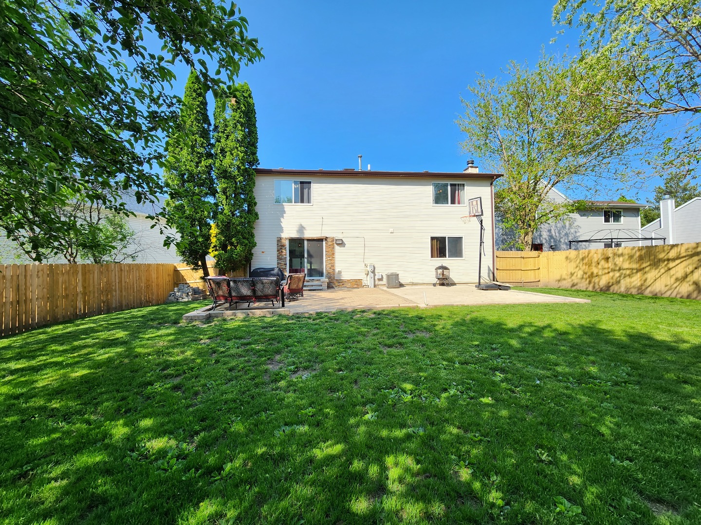 696 Dover Drive Elgin, IL 60120 - Photo 31 of 32 a view of a house with backyard and a tree