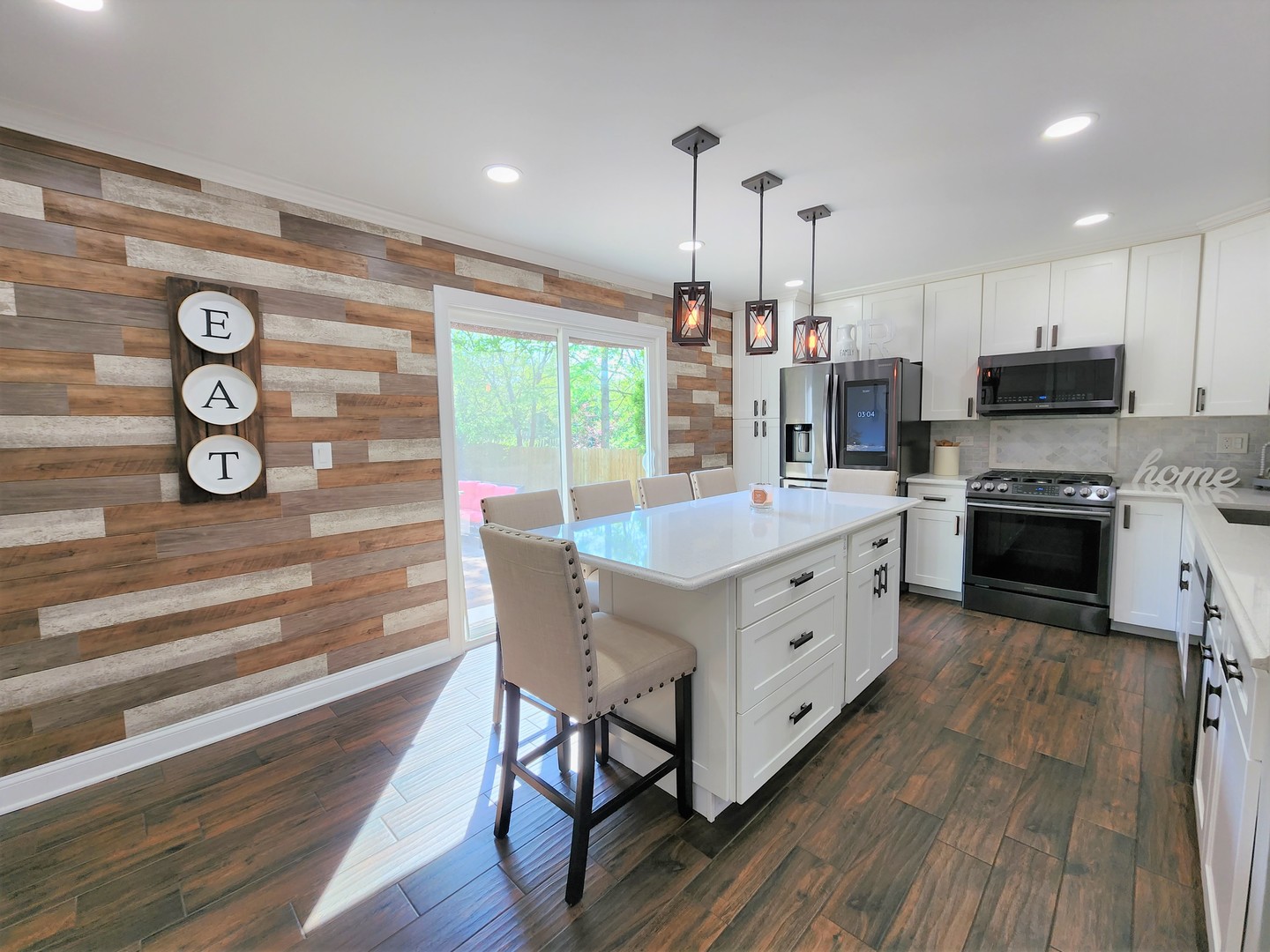 696 Dover Drive Elgin, IL 60120 - Photo 4 of 32 a kitchen with stainless steel appliances a stove top oven a sink and cabinets