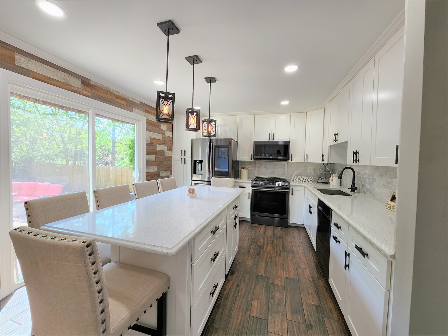 696 Dover Drive Elgin, IL 60120 - Photo 5 of 32 a kitchen with stainless steel appliances granite countertop a sink a stove and a refrigerator