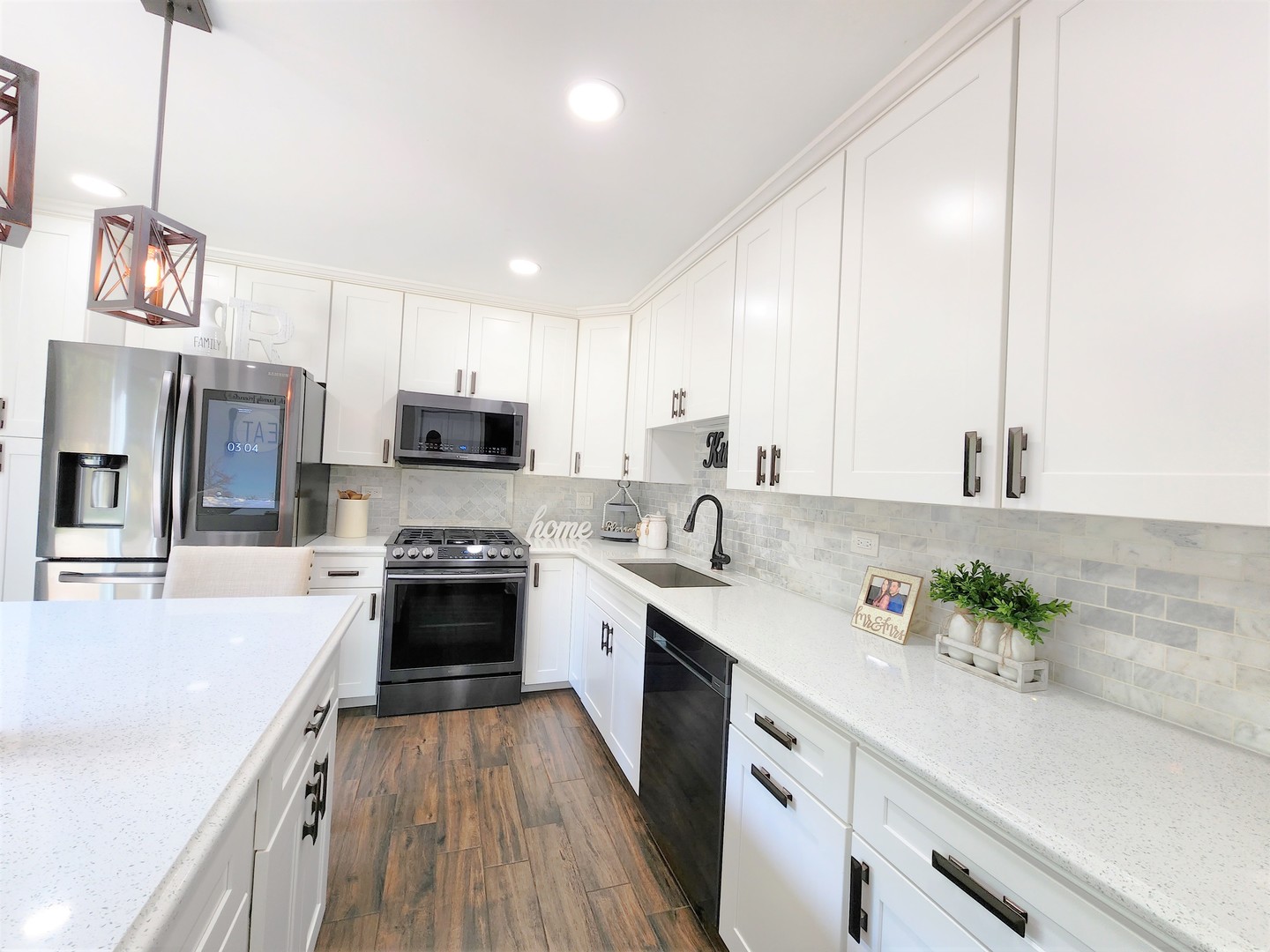 696 Dover Drive Elgin, IL 60120 - Photo 6 of 32 a kitchen with stainless steel appliances a stove a sink dishwasher a refrigerator and a oven with wooden floor