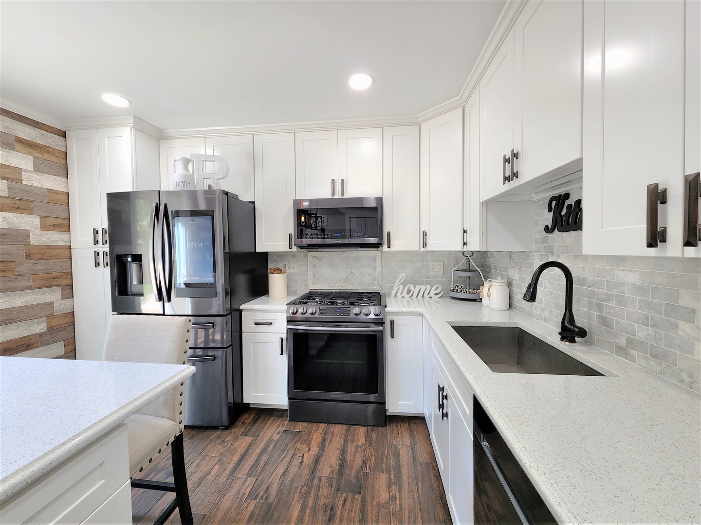 696 Dover Drive Elgin, IL 60120 - Photo 7 of 32 a kitchen with stainless steel appliances granite countertop a sink dishwasher a refrigerator and a stove with wooden floor