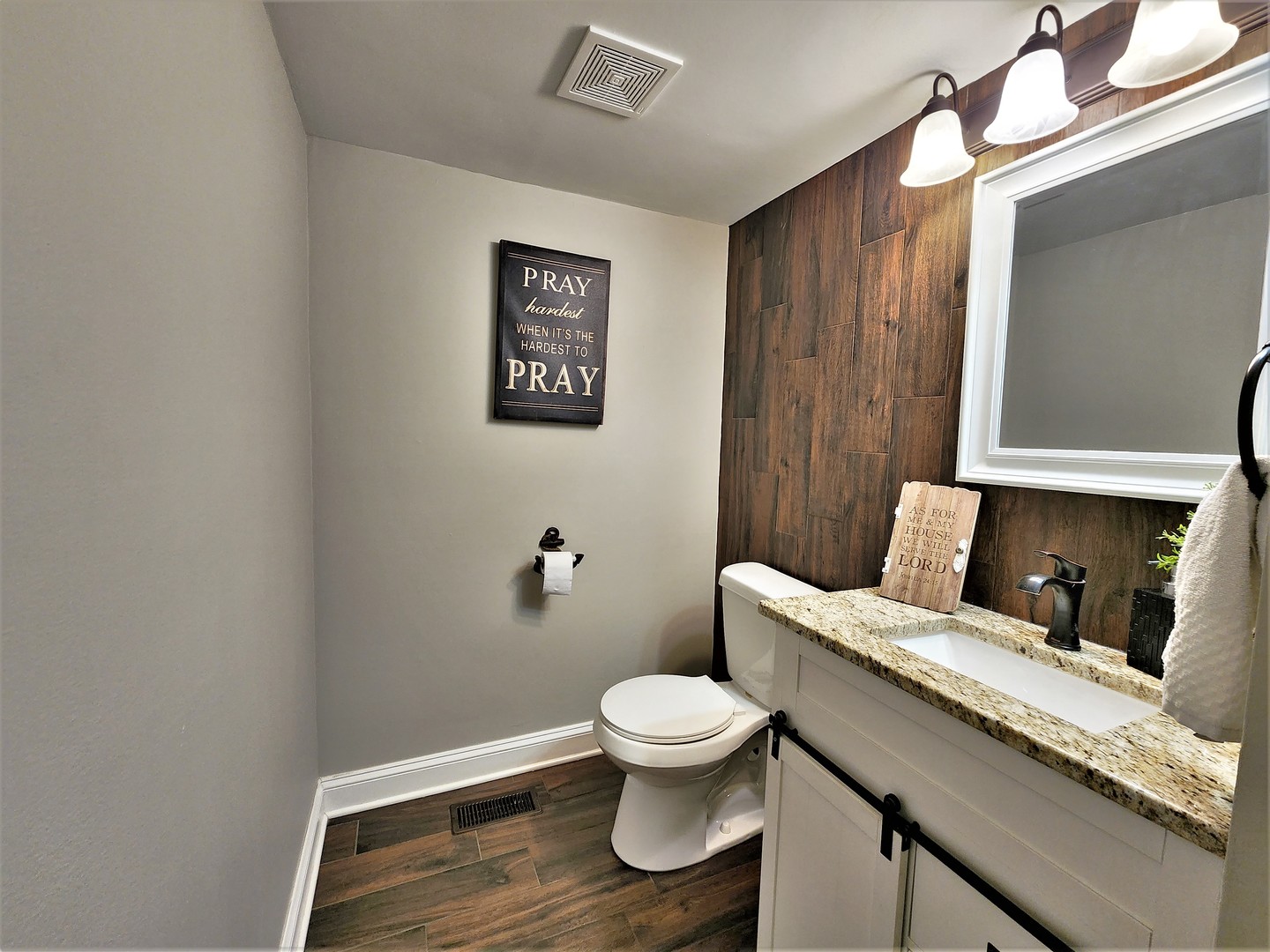 696 Dover Drive Elgin, IL 60120 - Photo 10 of 32 a bathroom with a toilet sink and mirror