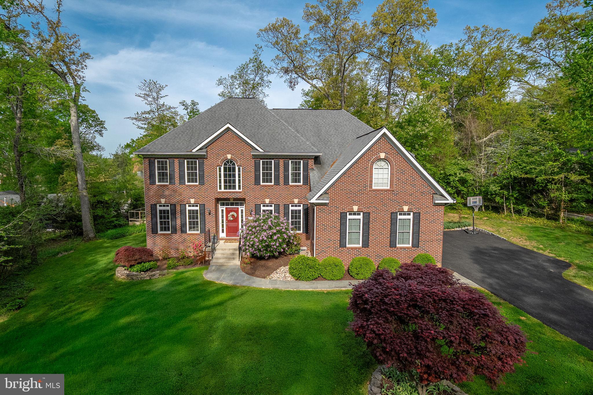1232 Shenandoah Road Alexandria, VA 22308 - Photo 1 of 50 a front view of a house with a garden and trees