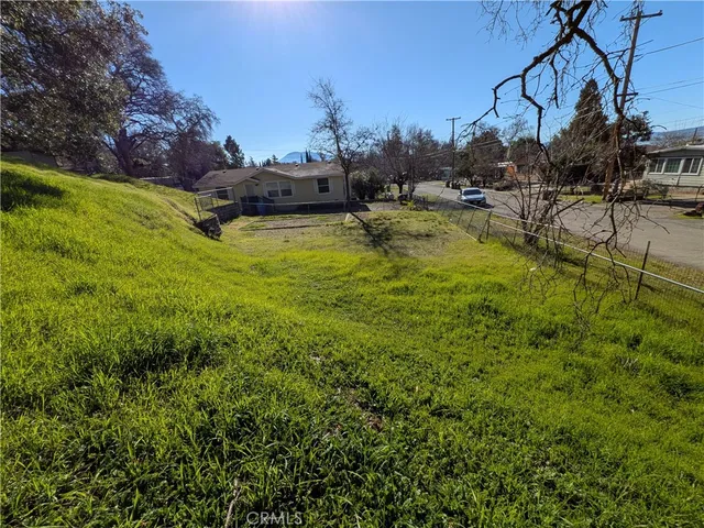a view of a swimming pool with a lawn chairs and a fire pit