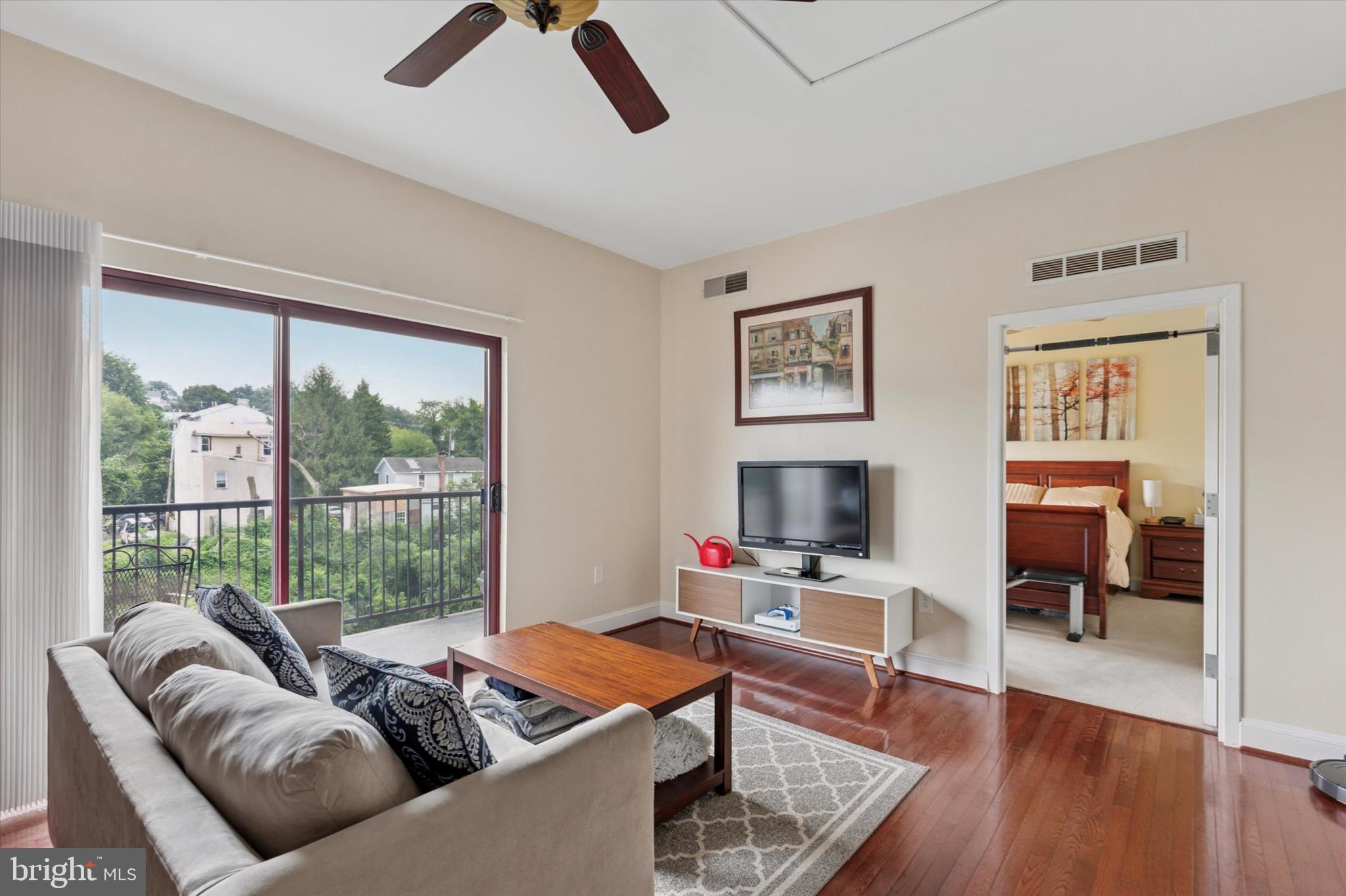a living room with furniture or couch and a wooden floor