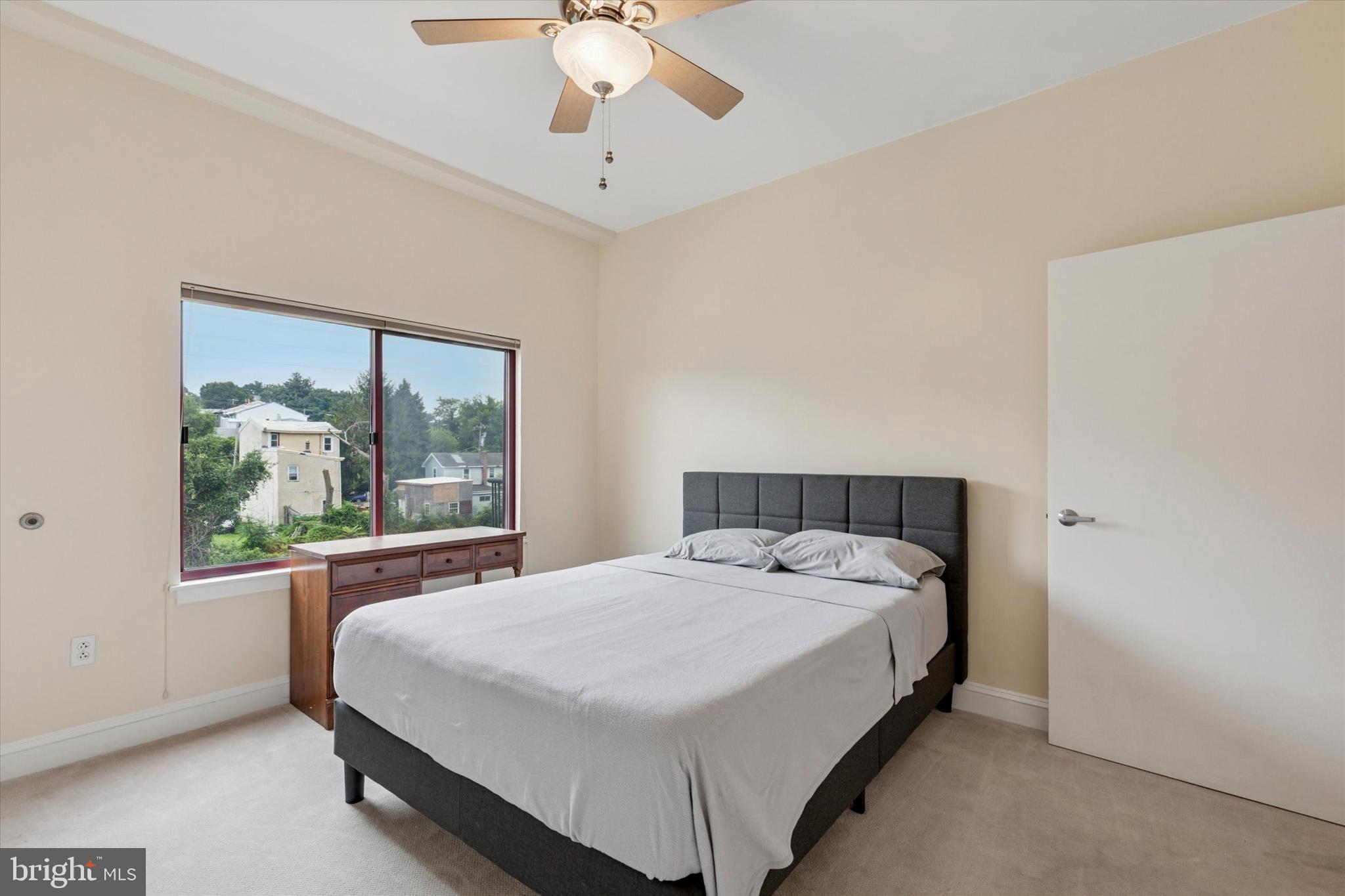 3750 Main Street, Unit 709 Philadelphia, PA 19127 - Photo 7 of 15 a large bed sitting in a bedroom next to a window