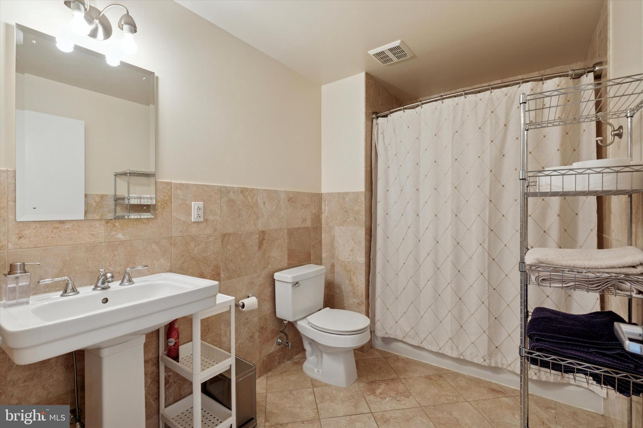 3750 Main Street, Unit 709 Philadelphia, PA 19127 - Photo 8 of 15 a bathroom with a sink toilet and shower