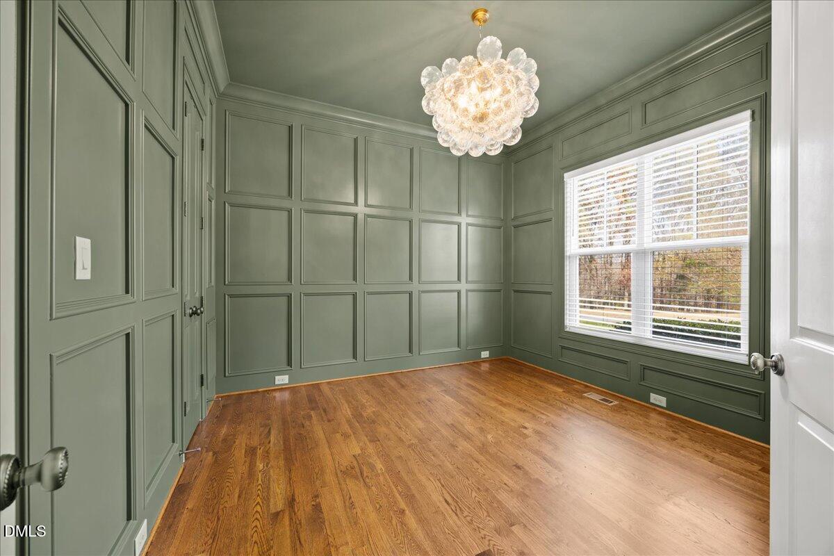 325 Forest Bridge Road Youngsville, NC 27596 - Photo 9 of 99 a view of a bedroom with a chandelier
