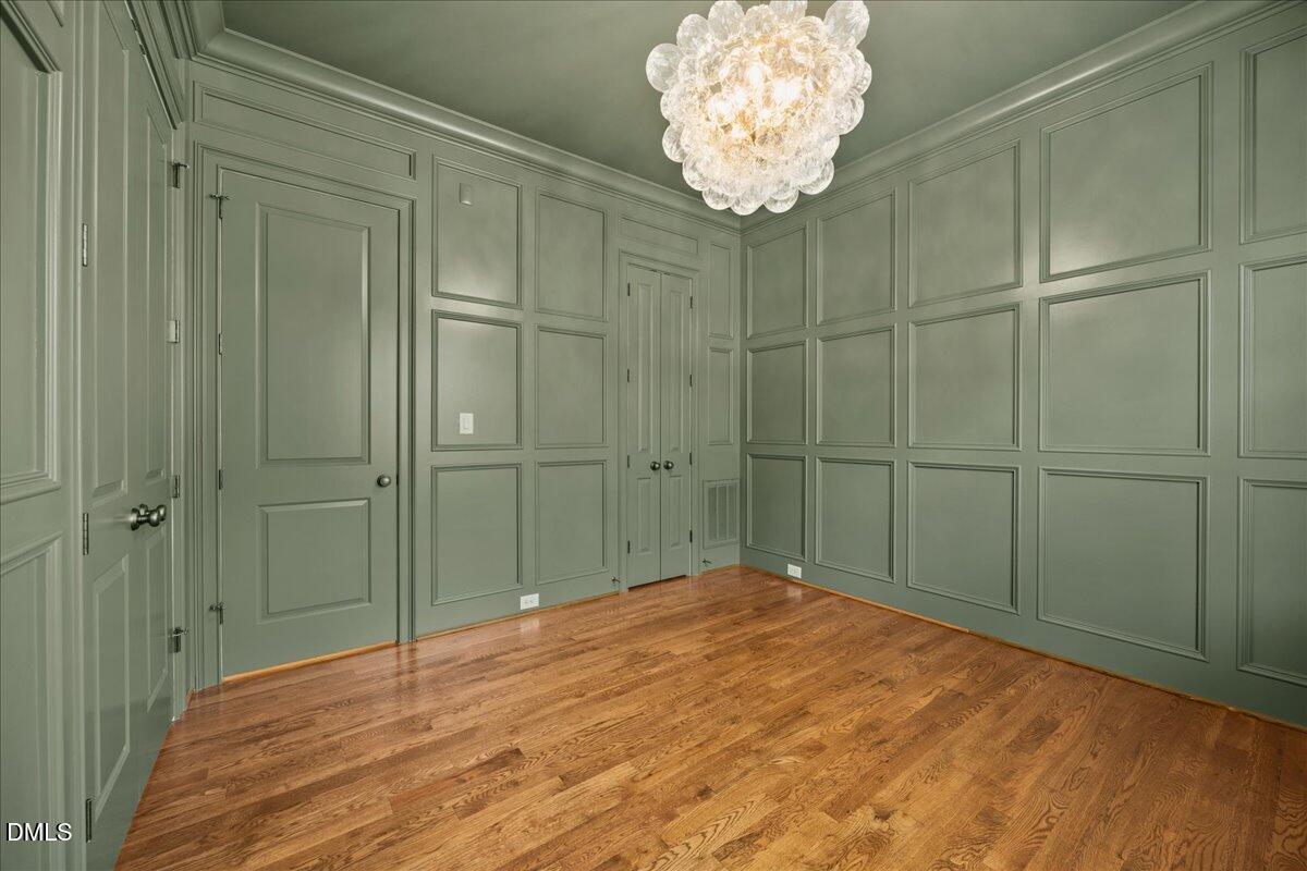 325 Forest Bridge Road Youngsville, NC 27596 - Photo 10 of 99 a bedroom with a chandelier and a chandelier fan