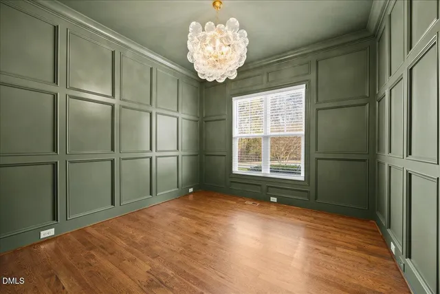 a living room with furniture and a dining table with wooden floor