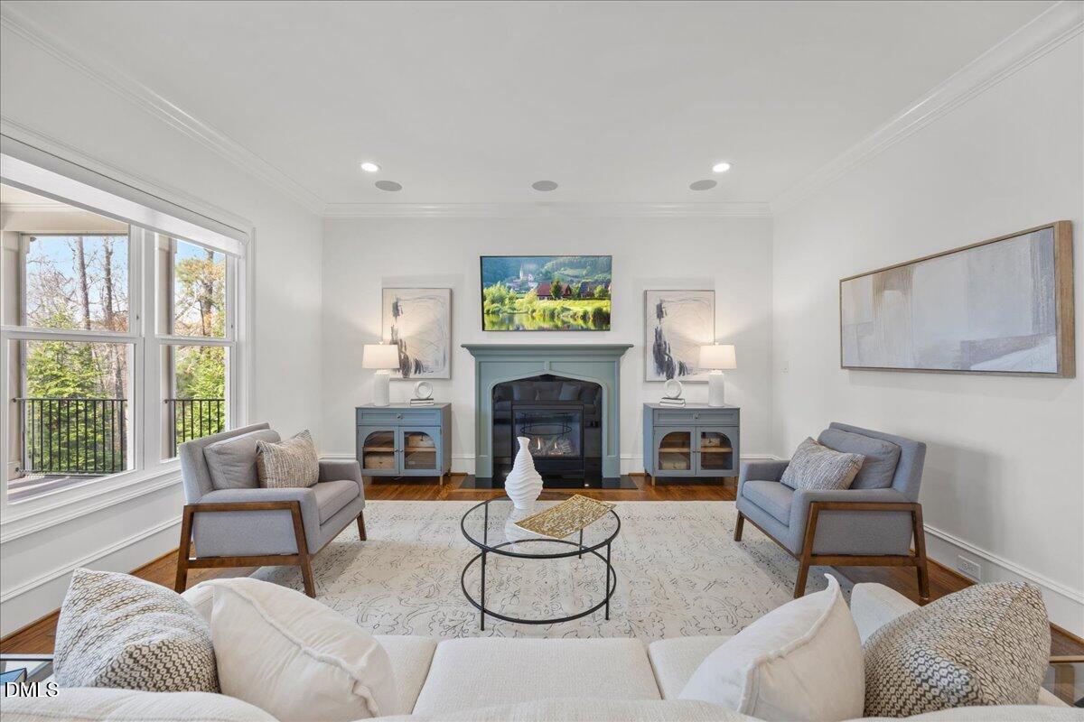 325 Forest Bridge Road Youngsville, NC 27596 - Photo 13 of 99 a living room with furniture a fireplace and a flat screen tv