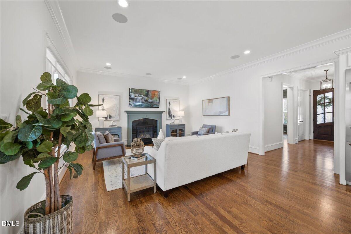 325 Forest Bridge Road Youngsville, NC 27596 - Photo 15 of 99 a living room with furniture a fireplace and a potted plant