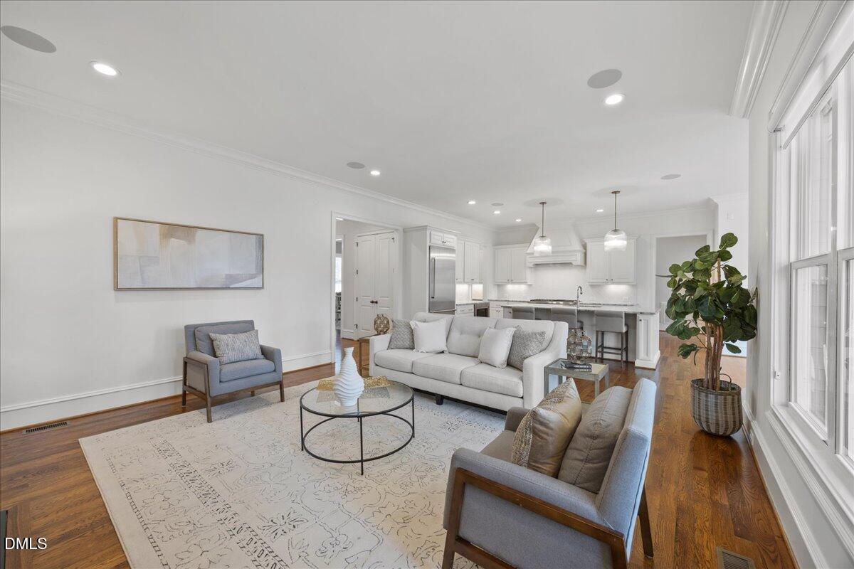 325 Forest Bridge Road Youngsville, NC 27596 - Photo 16 of 99 a living room with furniture and a dining table with wooden floor