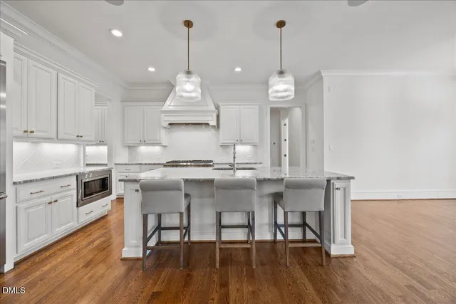 a bathroom with a granite countertop sink a toilet and shower