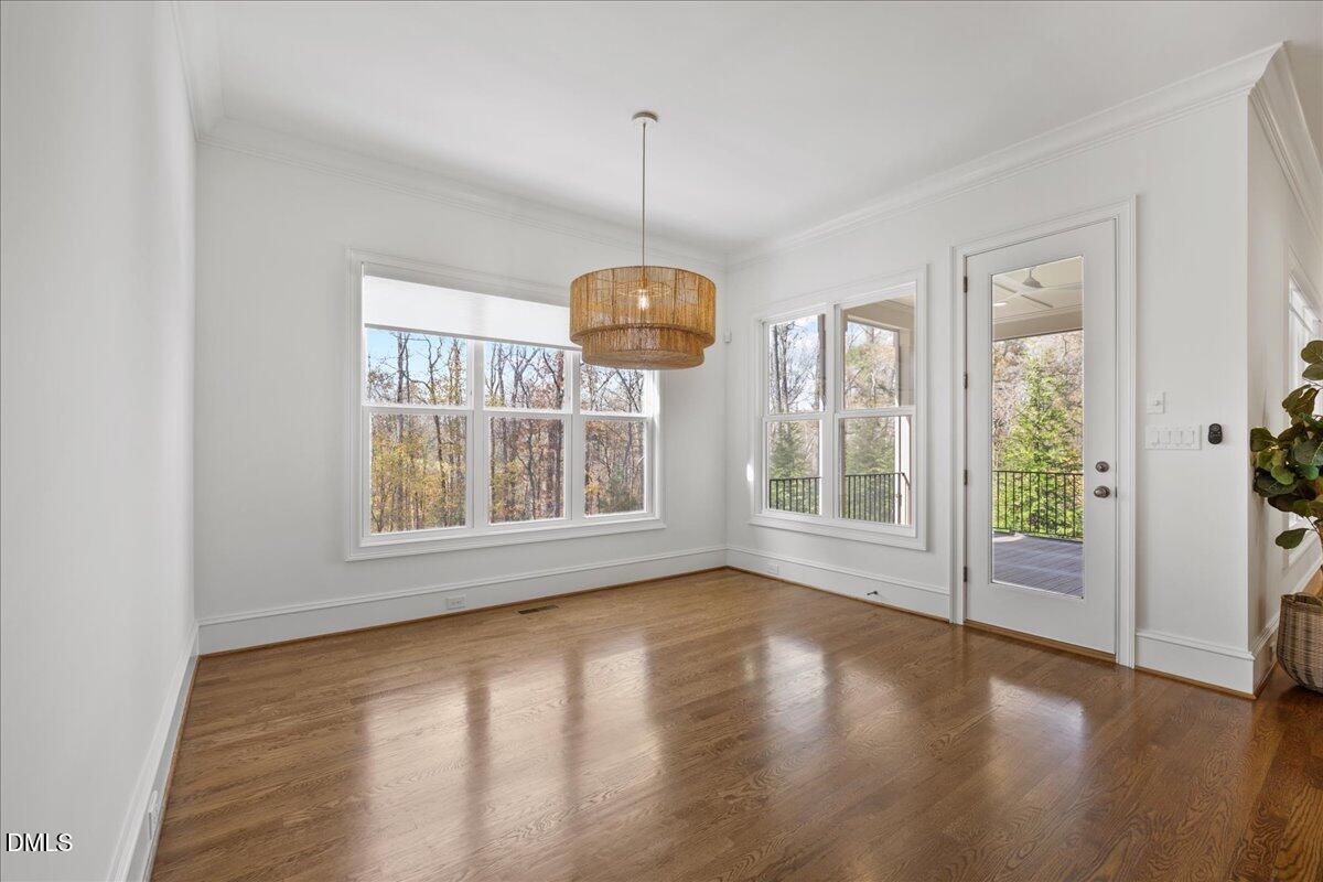 325 Forest Bridge Road Youngsville, NC 27596 - Photo 21 of 99 a view of an empty room with wooden floor and a window