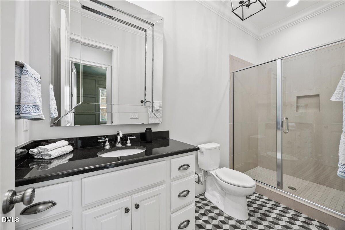 325 Forest Bridge Road Youngsville, NC 27596 - Photo 24 of 99 a bathroom with a granite countertop sink a toilet and shower