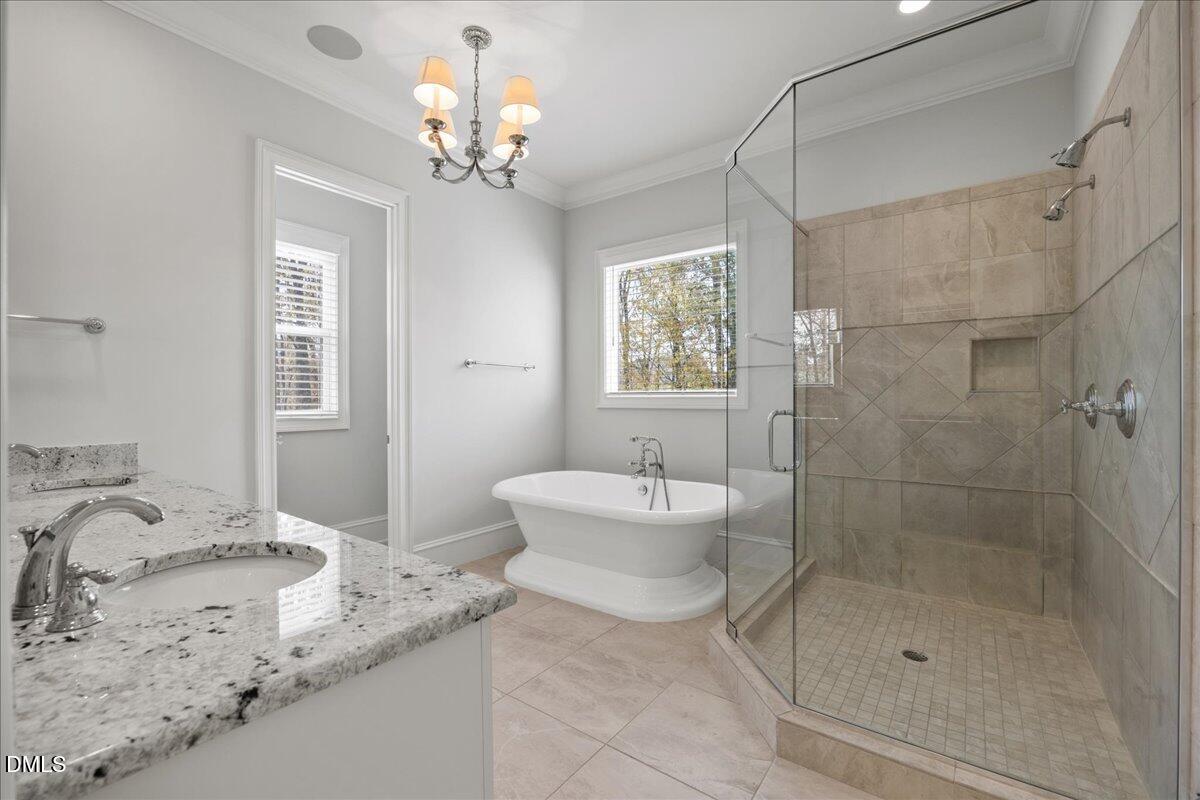 325 Forest Bridge Road Youngsville, NC 27596 - Photo 27 of 99 a bathroom with a granite countertop sink a toilet and shower