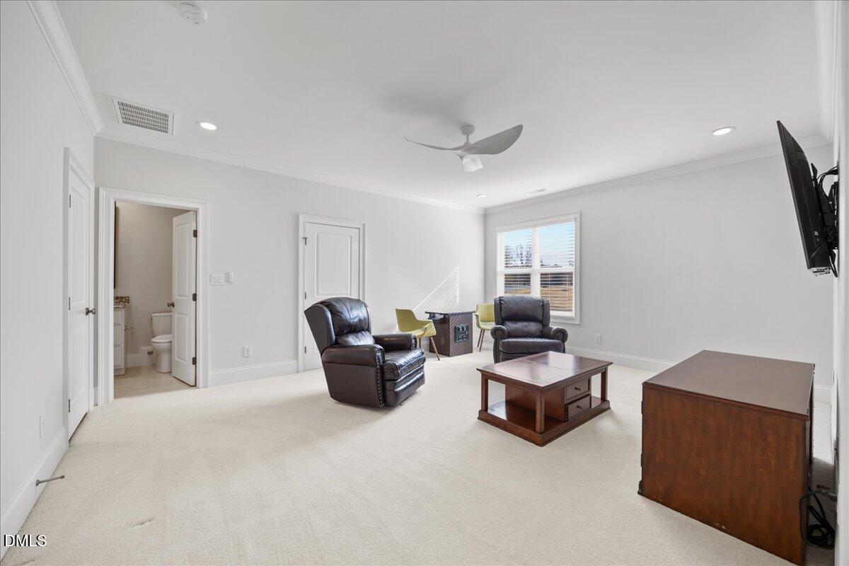 325 Forest Bridge Road Youngsville, NC 27596 - Photo 35 of 99 a living room with furniture and a flat screen tv