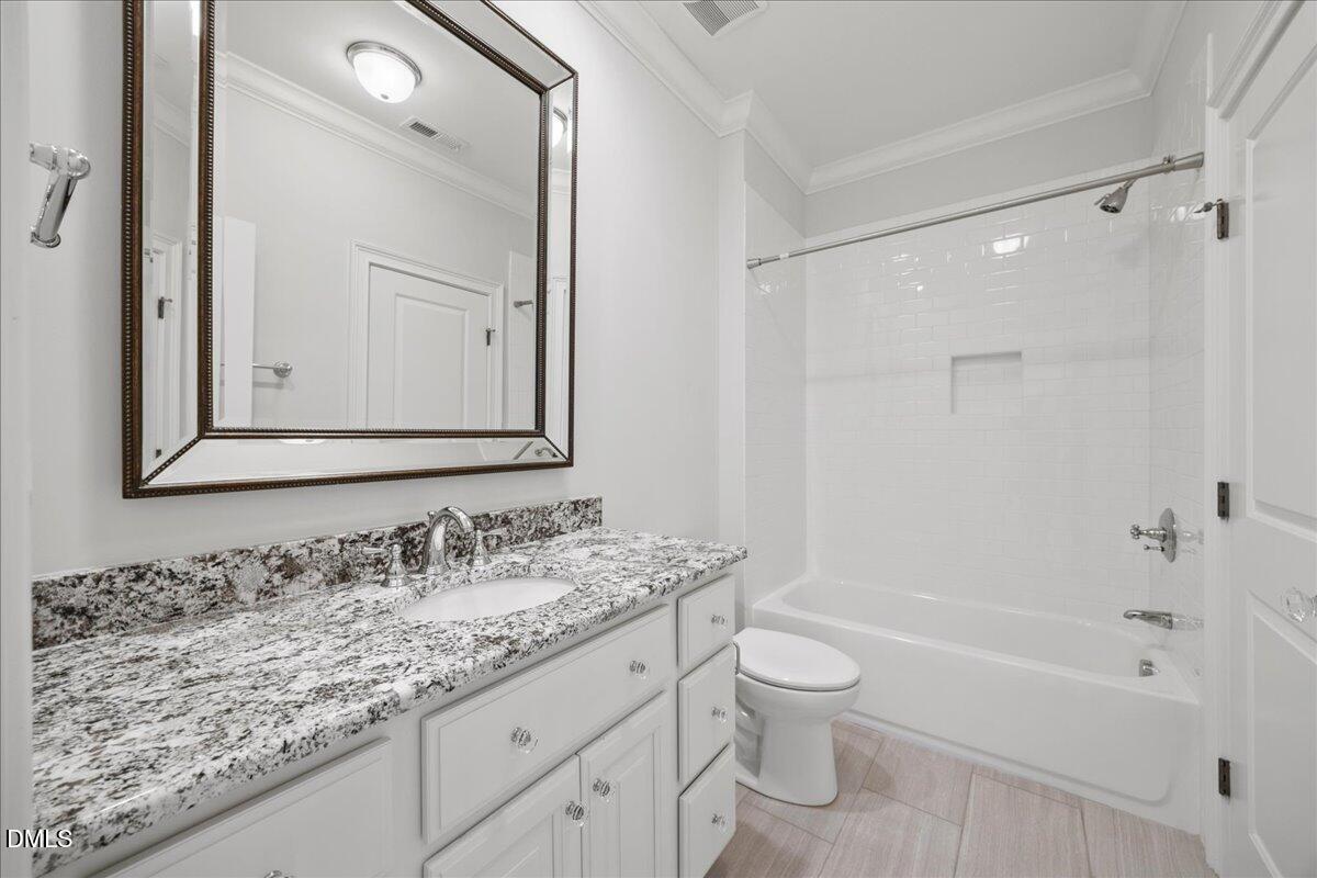 325 Forest Bridge Road Youngsville, NC 27596 - Photo 37 of 99 a bathroom with a granite countertop sink a toilet and a bathtub