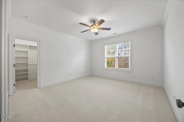 a living room with stainless steel appliances furniture a window and a kitchen view