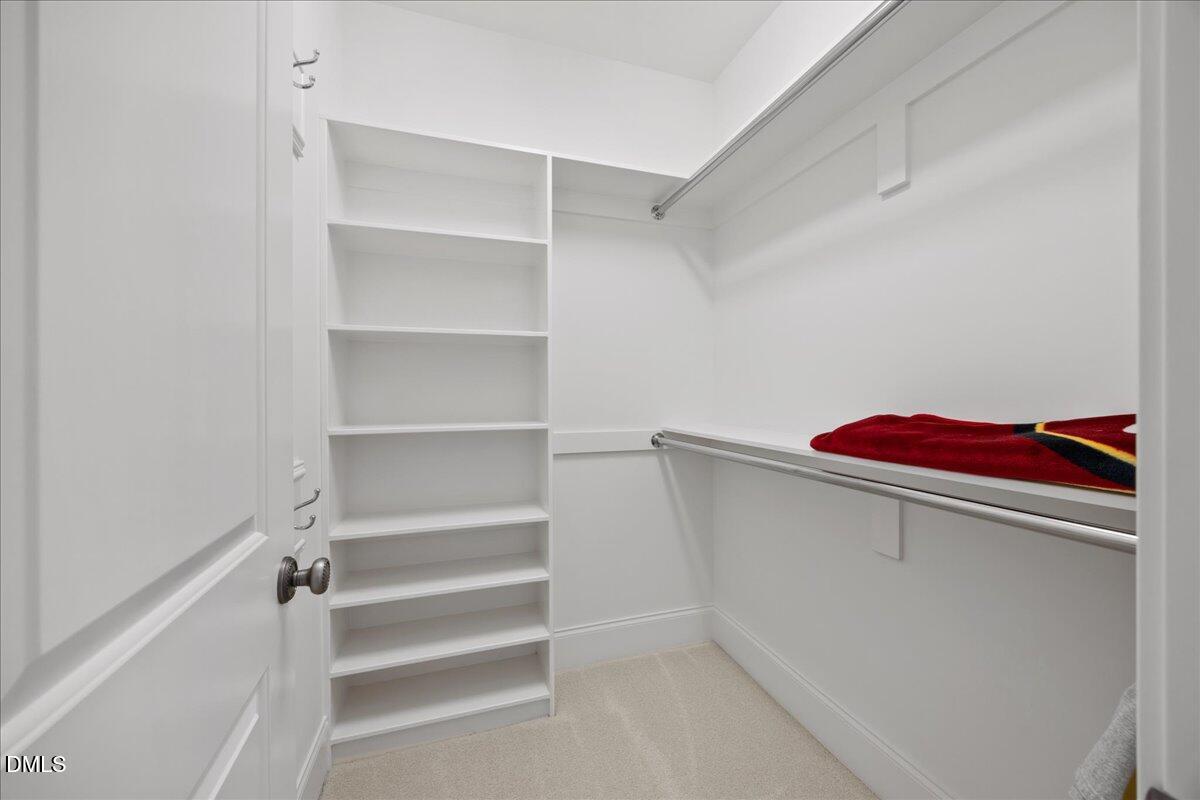 325 Forest Bridge Road Youngsville, NC 27596 - Photo 39 of 99 a view of walk in closet with empty racks