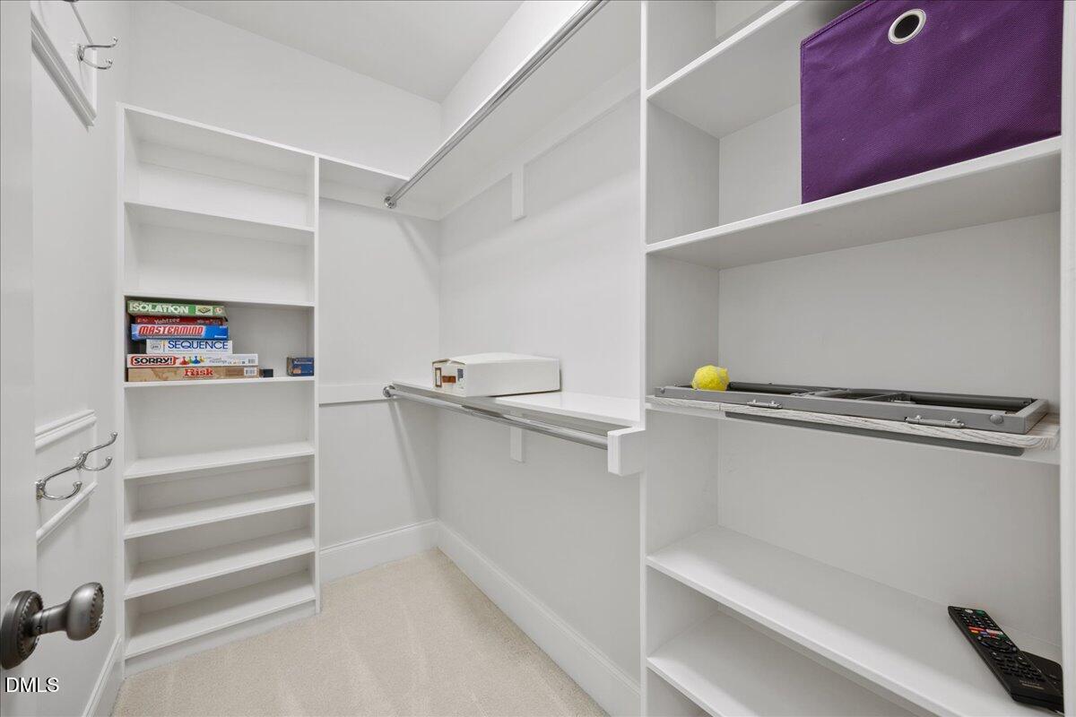 325 Forest Bridge Road Youngsville, NC 27596 - Photo 41 of 99 a view of walk in closet with empty racks