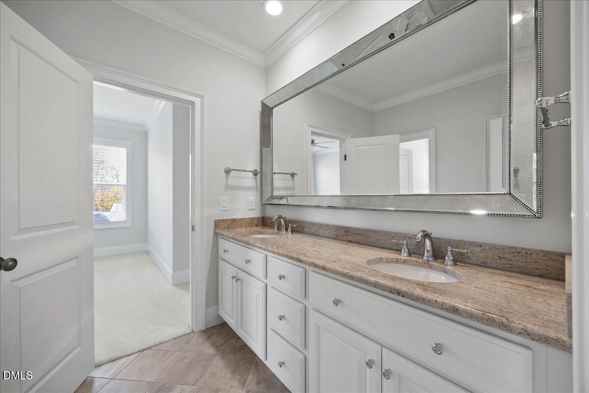 325 Forest Bridge Road Youngsville, NC 27596 - Photo 42 of 99 a bathroom with a granite countertop sink double and mirror