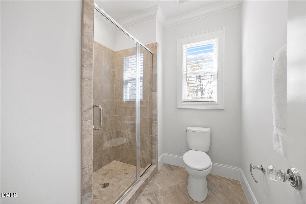 325 Forest Bridge Road Youngsville, NC 27596 - Photo 43 of 99 a bathroom with a toilet a sink and shower