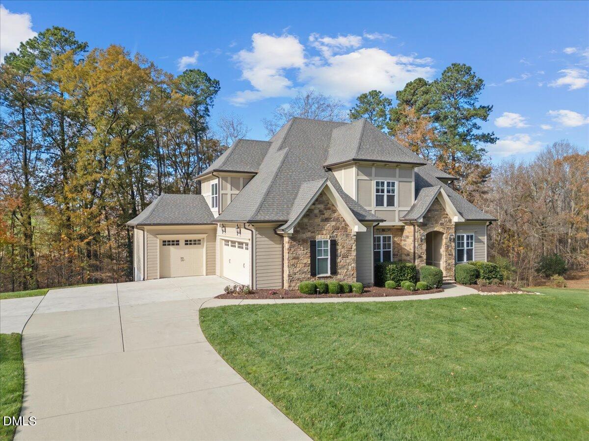 325 Forest Bridge Road Youngsville, NC 27596 - Photo 3 of 99 a front view of a house with a garden