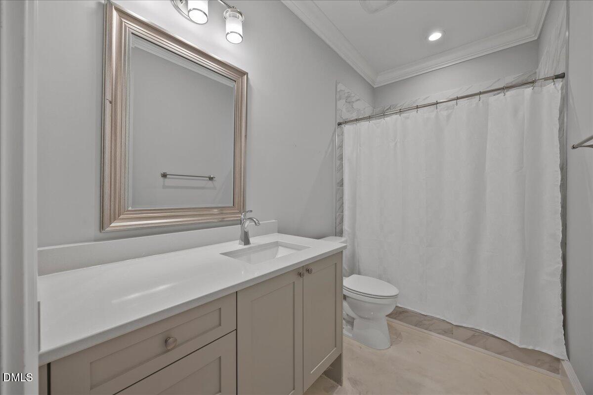 325 Forest Bridge Road Youngsville, NC 27596 - Photo 58 of 99 a bathroom with a sink a toilet and a mirror