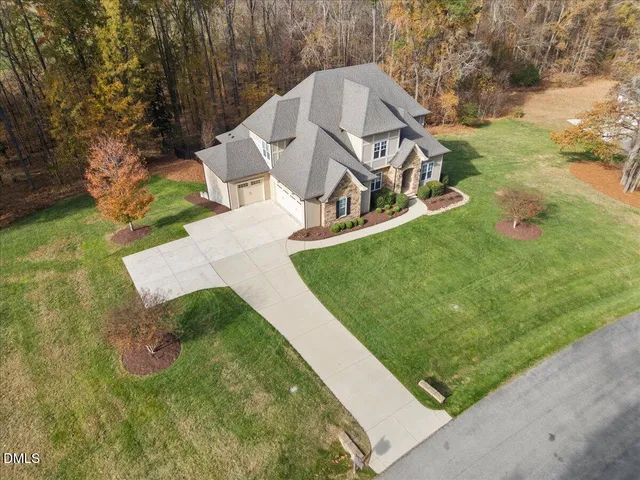 an aerial view of a house with garden space and street view