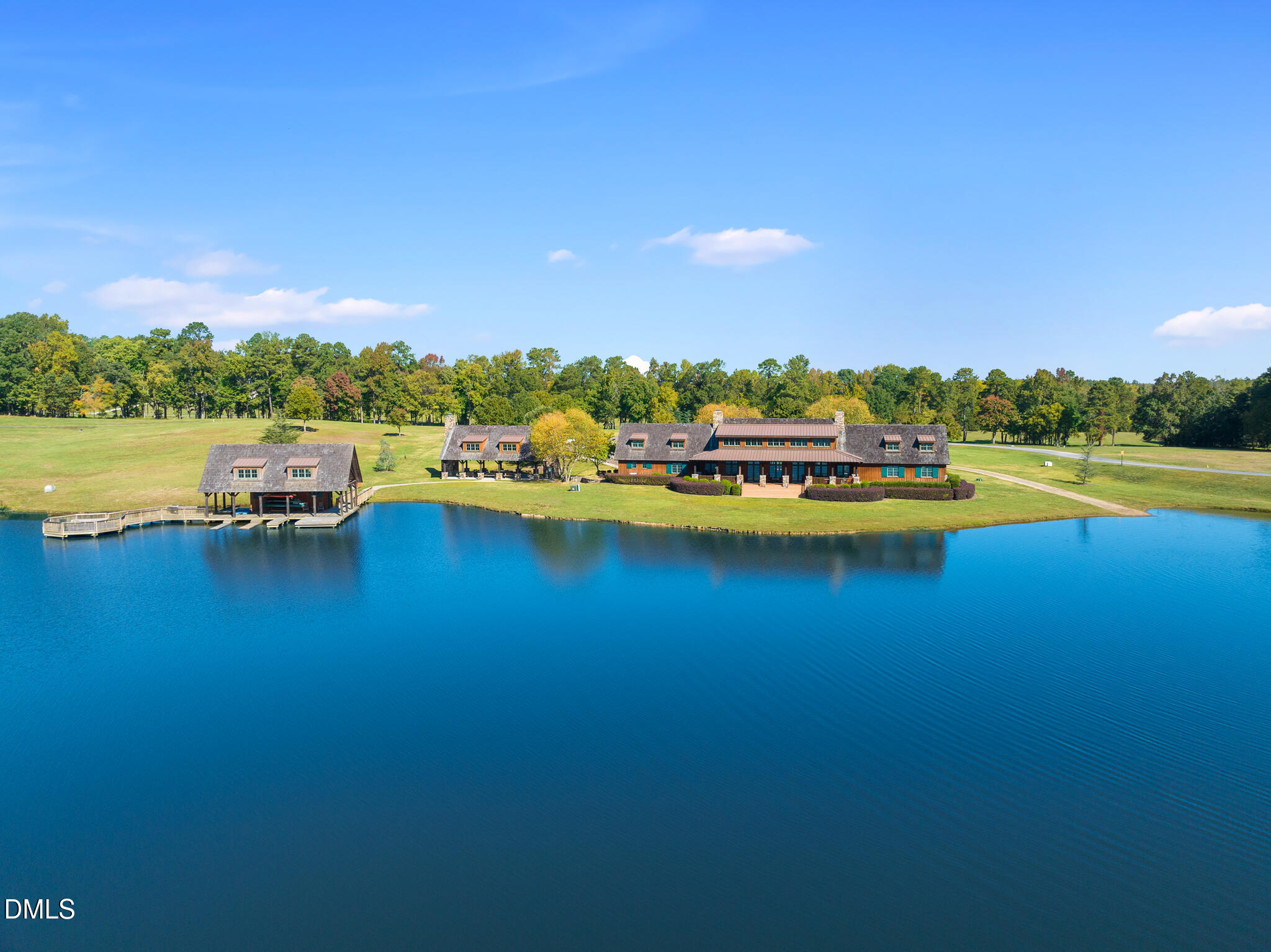 325 Forest Bridge Road Youngsville, NC 27596 - Photo 76 of 99 a view of a lake with houses in the back