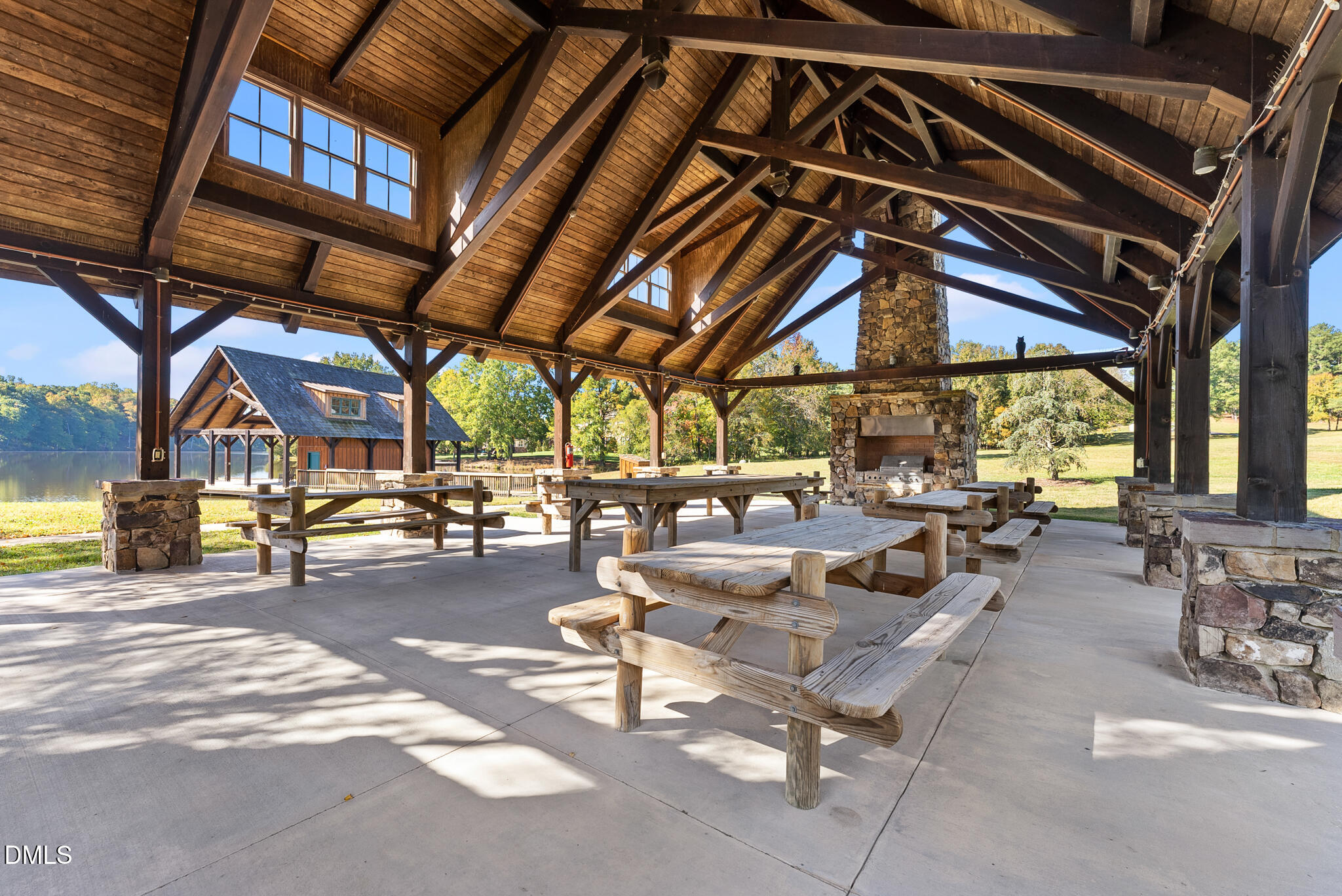 325 Forest Bridge Road Youngsville, NC 27596 - Photo 81 of 99 a view of a patio with table and chairs under an umbrella with a barbeque