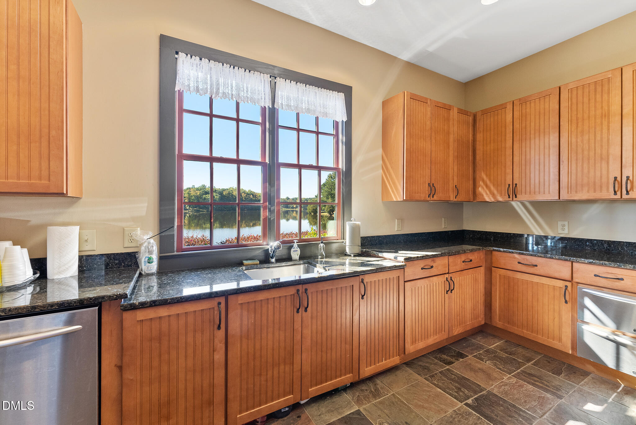 325 Forest Bridge Road Youngsville, NC 27596 - Photo 92 of 99 a kitchen with stainless steel appliances granite countertop a sink and a window