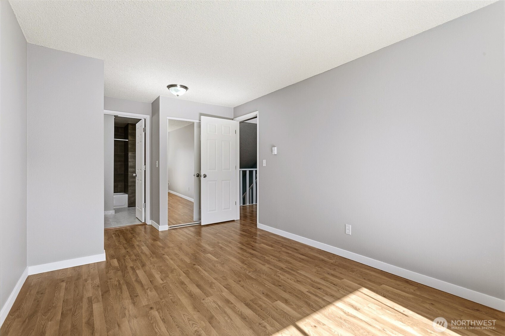 1802 Maple Lane, Unit A5 Kent, WA 98030 - Photo 12 of 27 a view of an empty room with wooden floor and a window