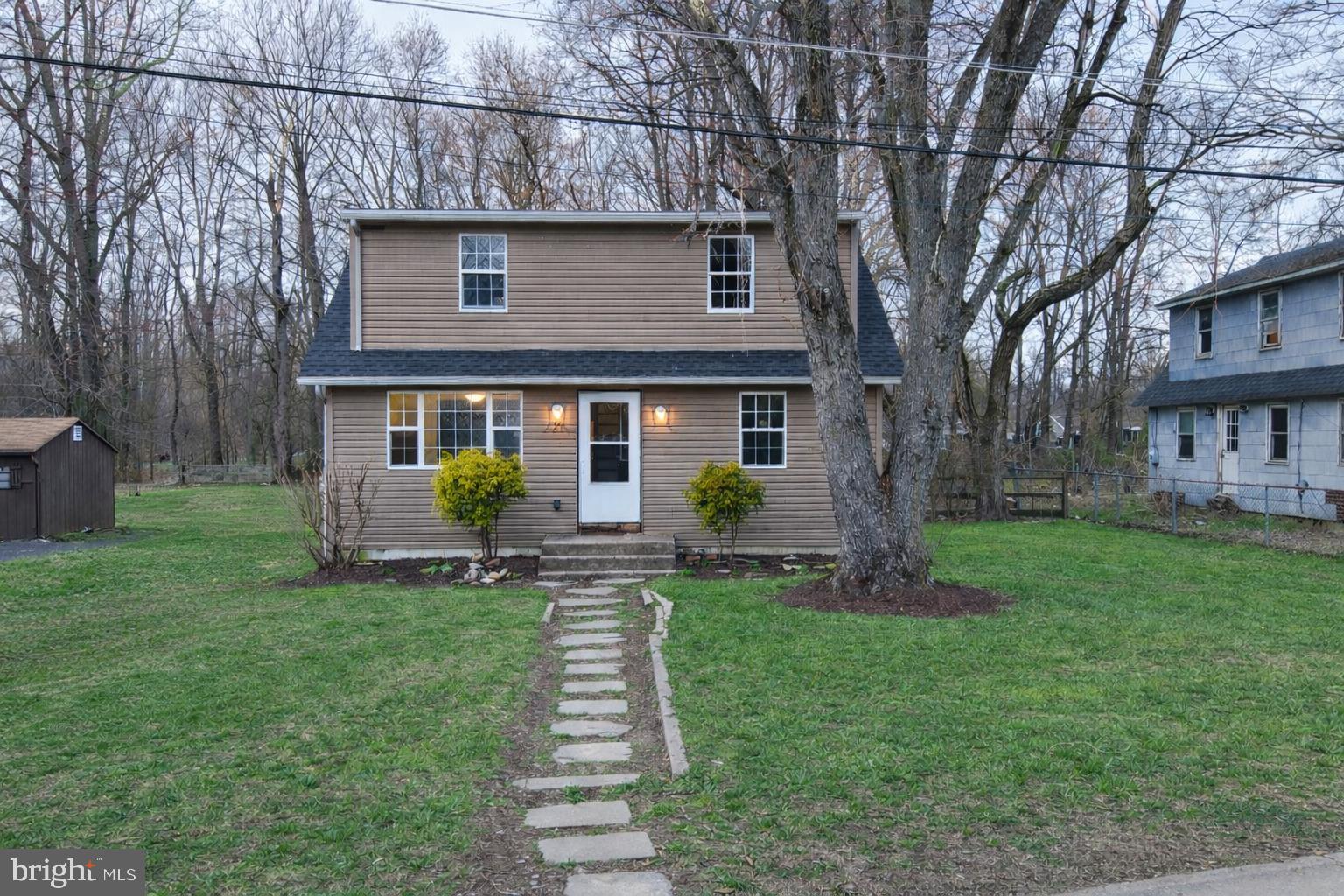 21 Sycamore Road Pennsville, NJ 08070 - Photo 1 of 31 a front view of a house with a yard and trees