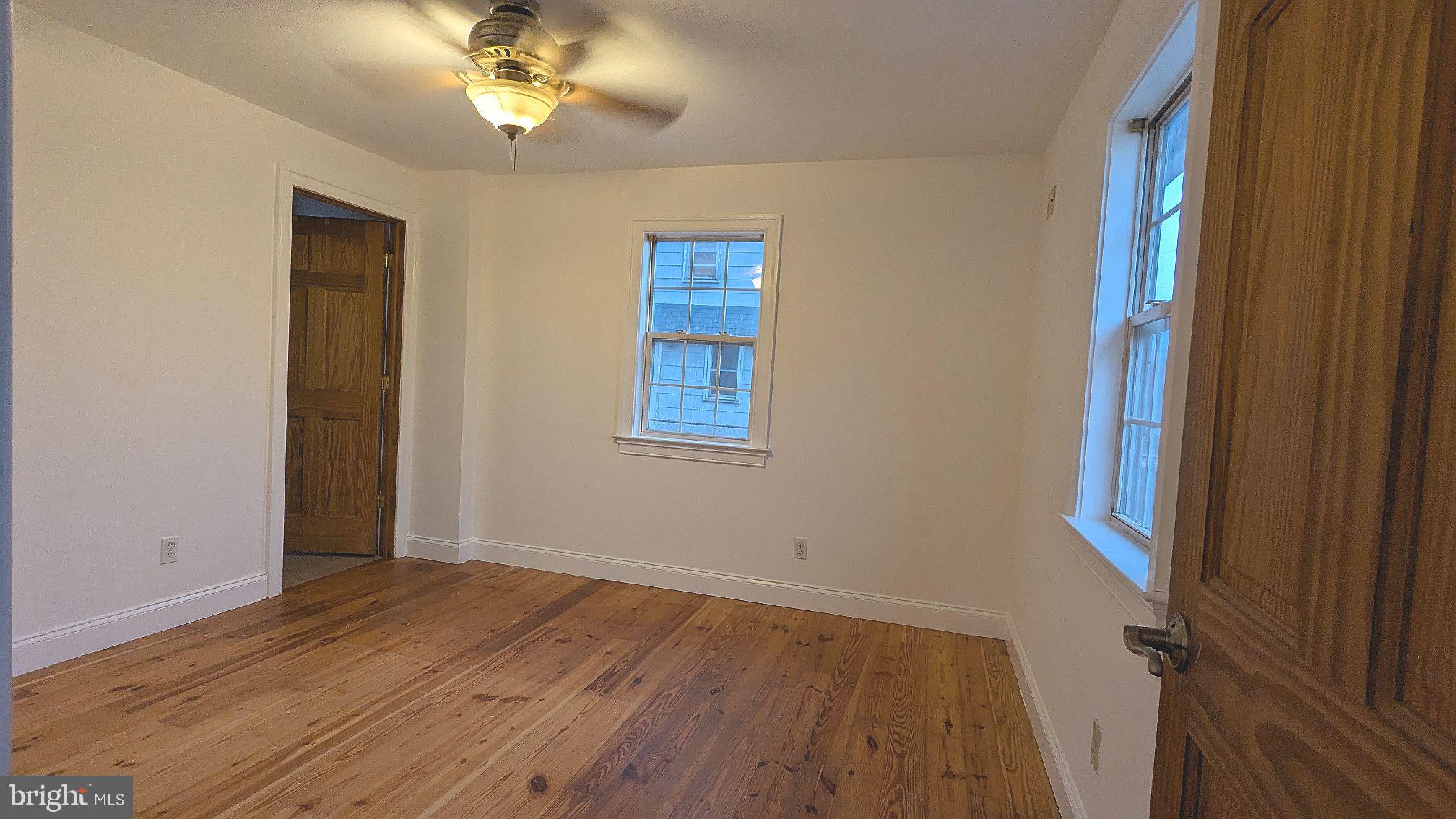 21 Sycamore Road Pennsville, NJ 08070 - Photo 22 of 31 wooden floor in an empty room with a window