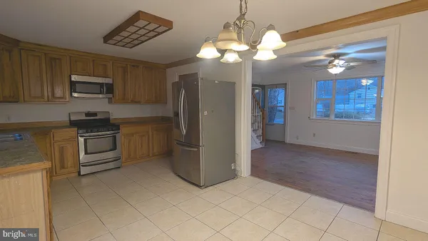 a kitchen with stainless steel appliances granite countertop a refrigerator a stove a sink and dishwasher