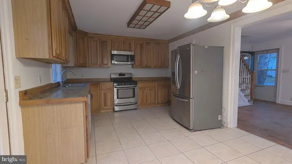 a kitchen with cabinets and stainless steel appliances