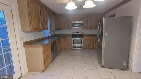 a kitchen with a sink cabinets and window