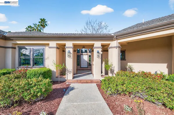 a view of a dining room with furniture a chandelier and wooden floor