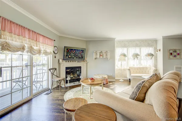 a living room with furniture a fireplace and a large window