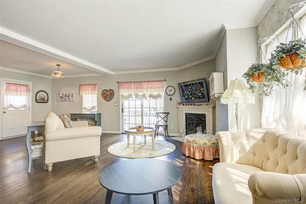a living room with furniture a fireplace and a floor to ceiling window