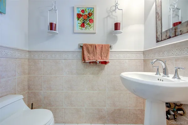 a bathroom with a sink mirror and toilet