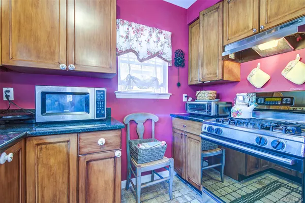a kitchen with stainless steel appliances granite countertop a stove and cabinets