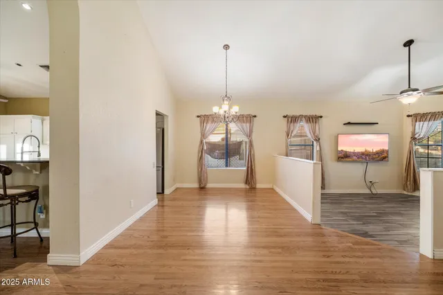 a view of a bedroom with a ceiling fan and a chandelier fan