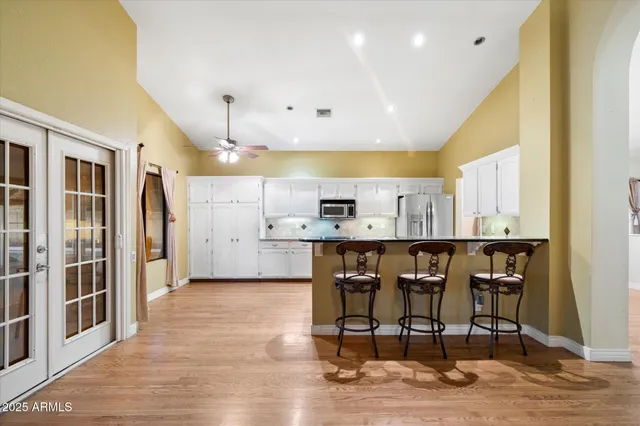 a bathroom with a granite countertop double vanity sinks and a mirror